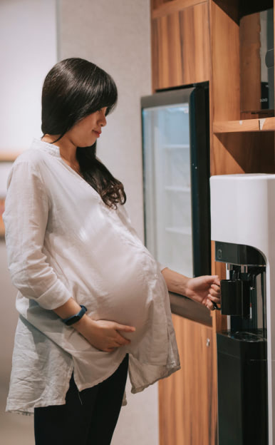 Pregnant Woman At Water Cooler
